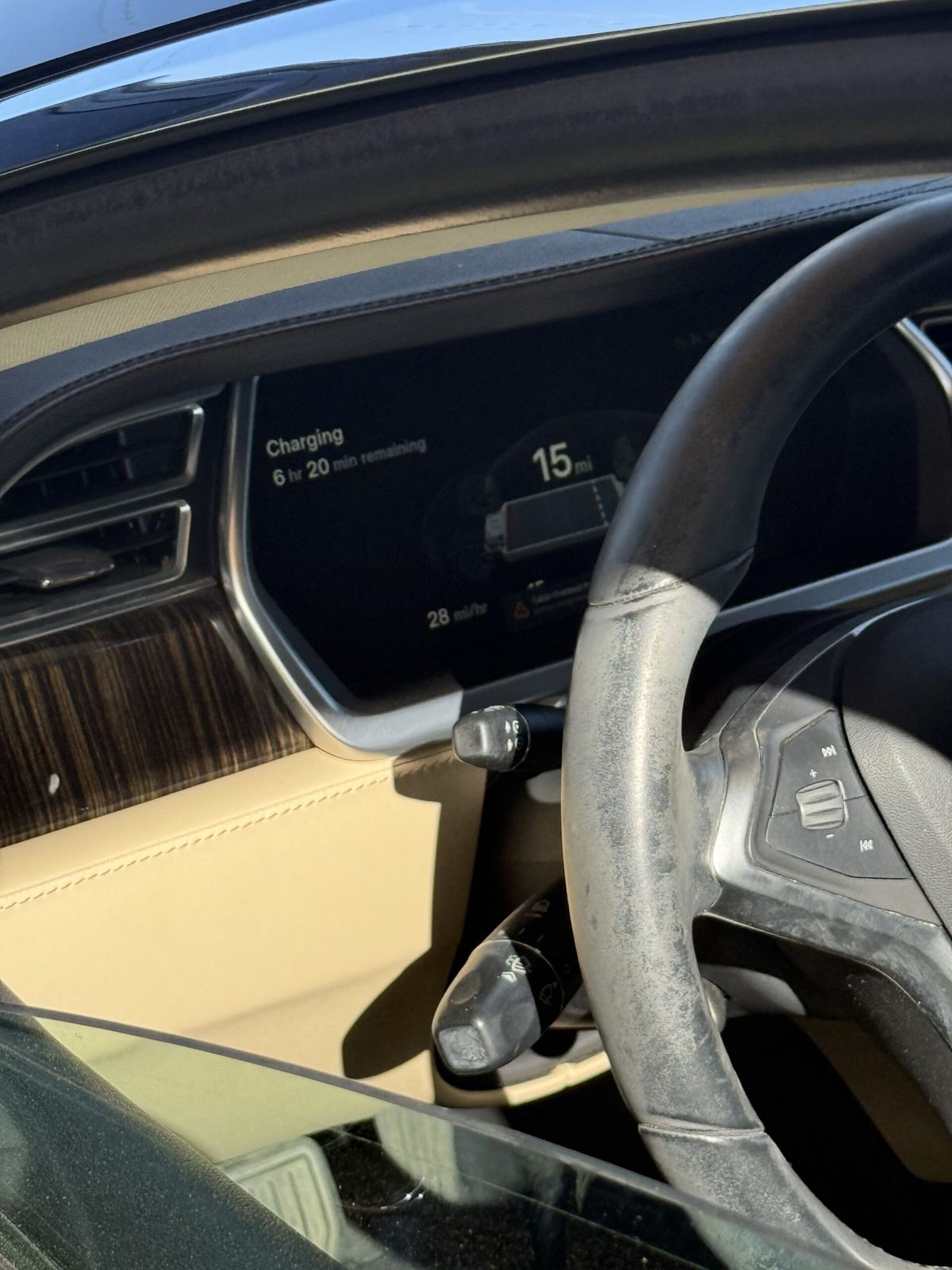 Mobile EV charging cable connected at an electric vehicle dashboard
